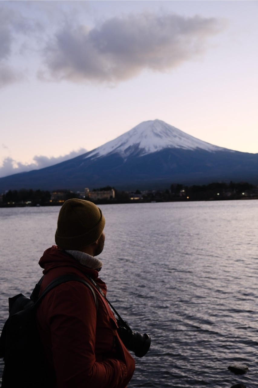 Danny Maiorca standing next to Mount Fuji at sunset